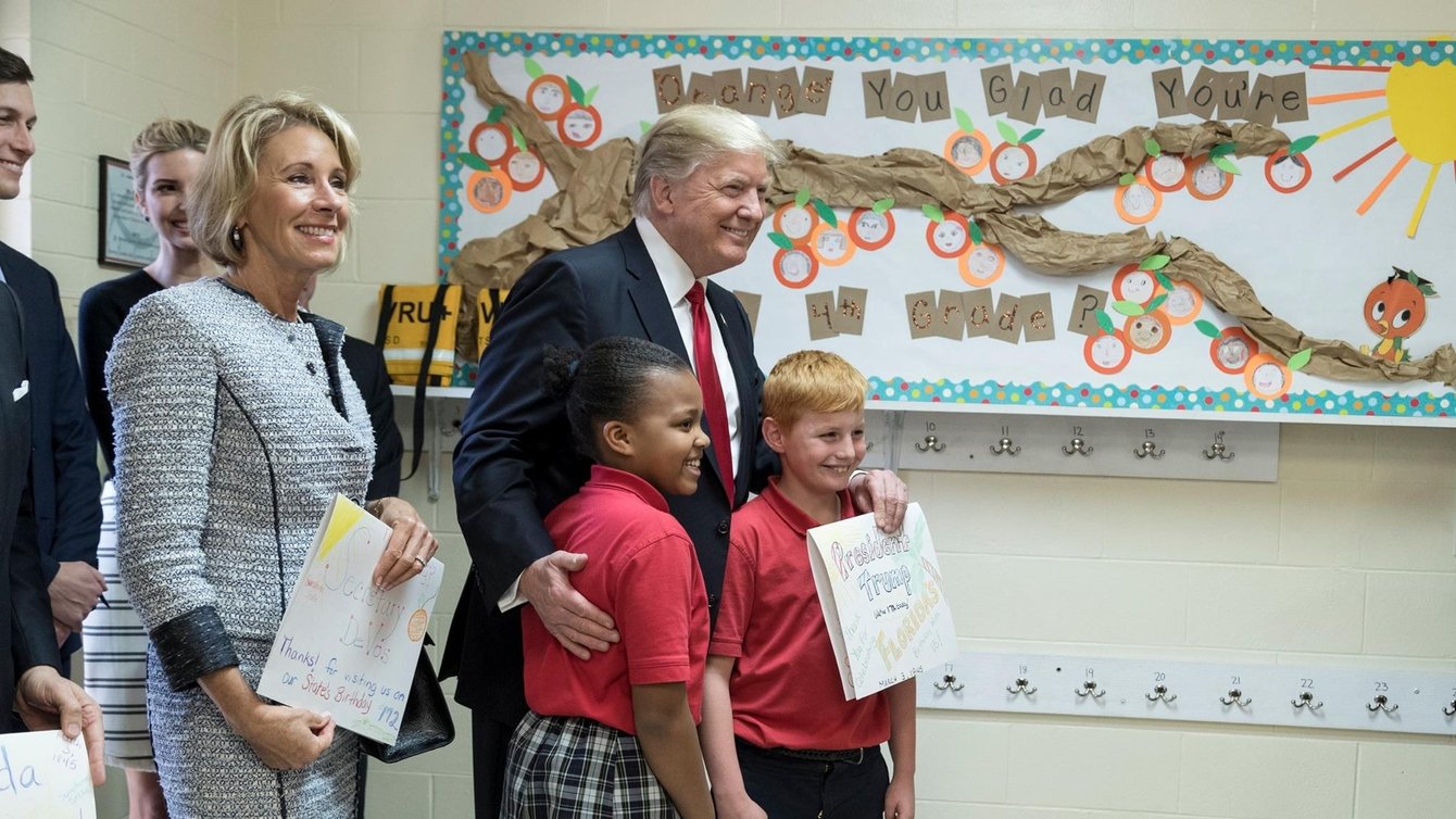 President Donald Trump and U.S. Secretary of Education Betsy DeVos poses for a photo with students of Saint Andrew Catholic School on March 3, 2017.