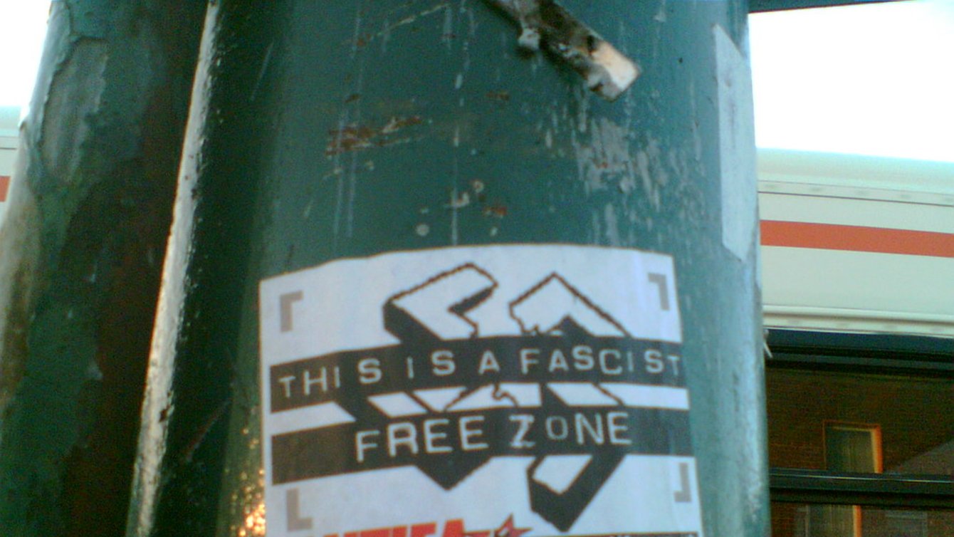 A flyer on a pillar that reads: "This is a fascist free zone. Antifa"
