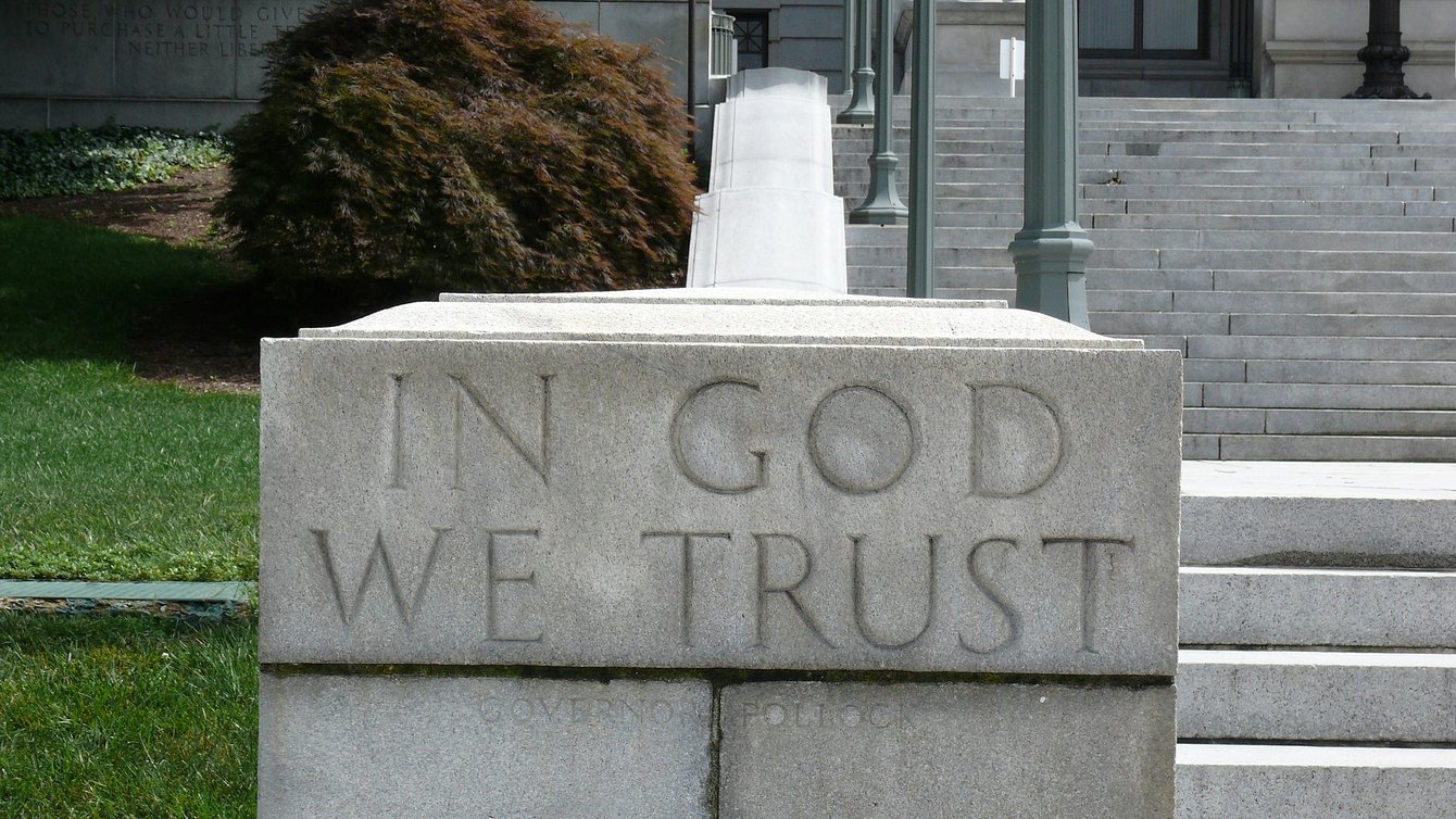  The word In God We Trust engraved in a stone staircase
