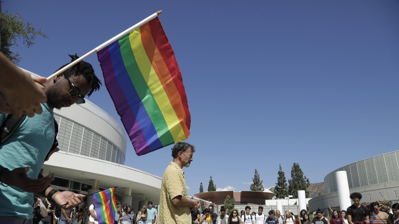 A professor offers a prayer during a rally by the LGBTQ Christian community at Azusa Pacific University to show support after the school reinstated a ban on same-sex relationships, October 1, 2018. Credit: Myung J. Chun/Los Angeles Times via Getty Images.
