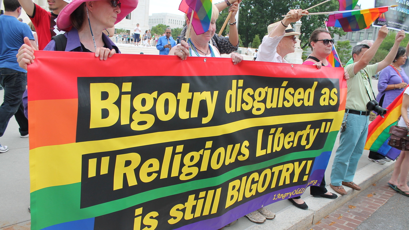 A rainbow flag with the words: Bigotry disguised as "Religious Liberty" is still Bigotry!