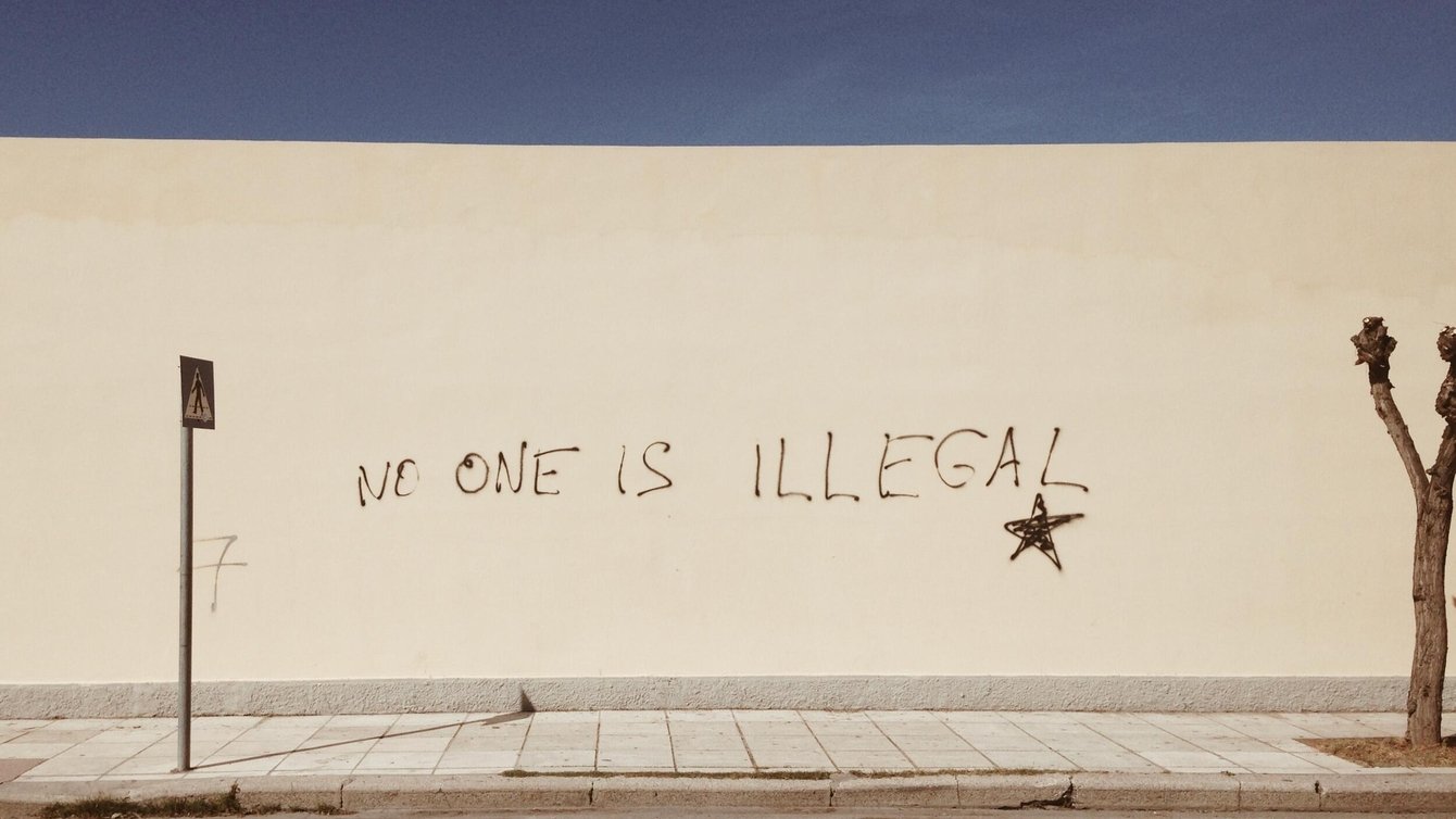 No One is Illegal painted on a wall