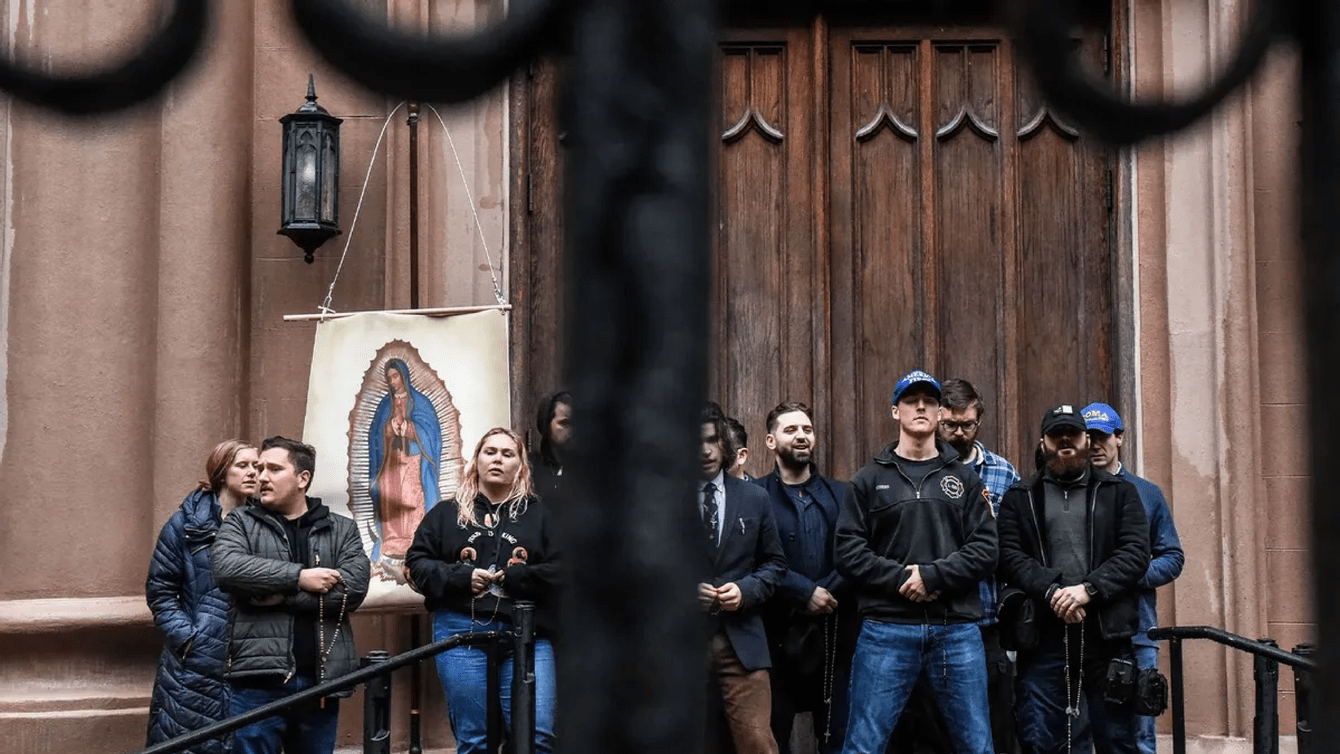 A group of people standing in front of a church.
