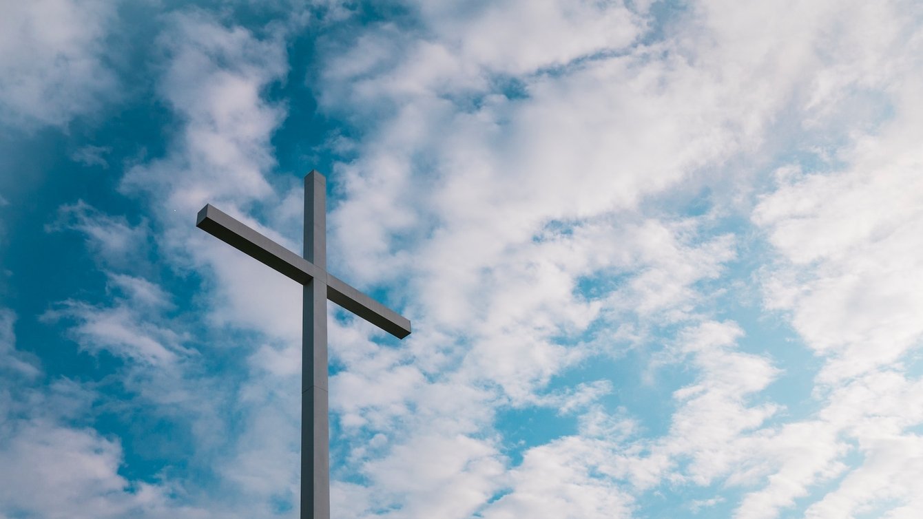 A cross with the sky in the background
