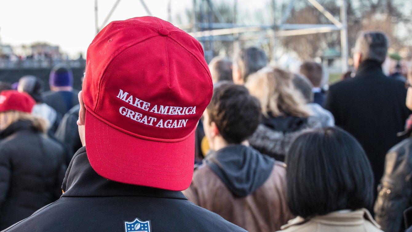 A Person wearing a MAGA hat backwards.