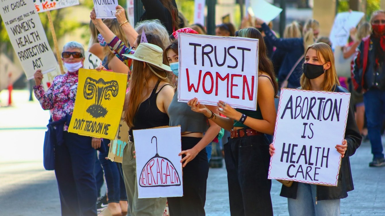 a group of protesters holding pro-abortion signs