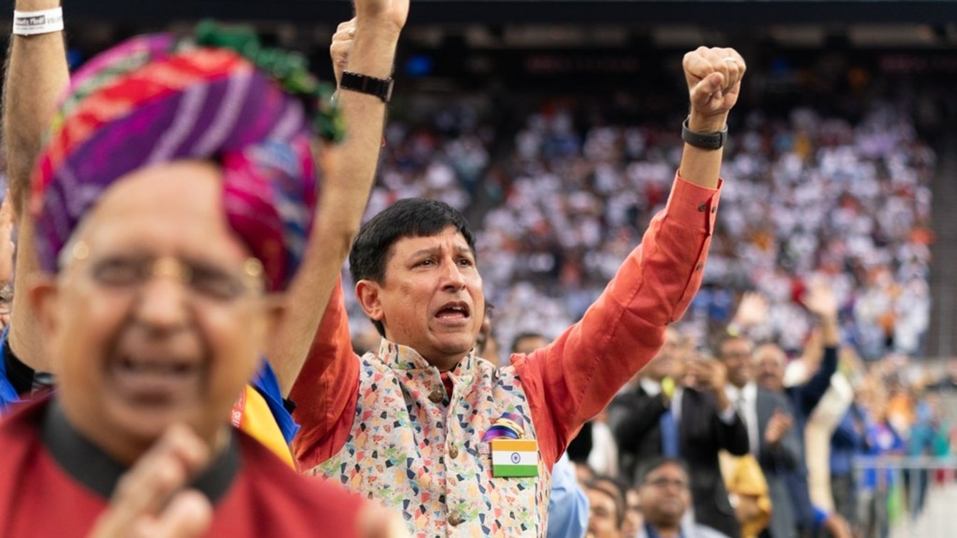 Group of people cheering with their arms in the air