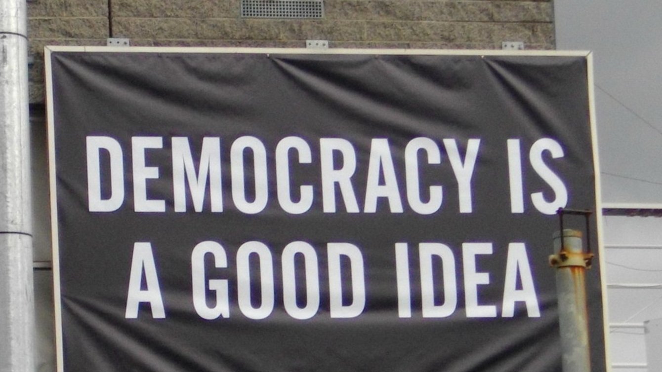 A banner that reads "Democracy is a good idea"