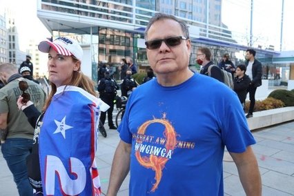 A trump supporter and a man wearing a QAnon T shirt