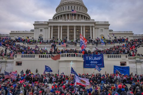 The Capitol building in D.C and Trump supporters all over it.