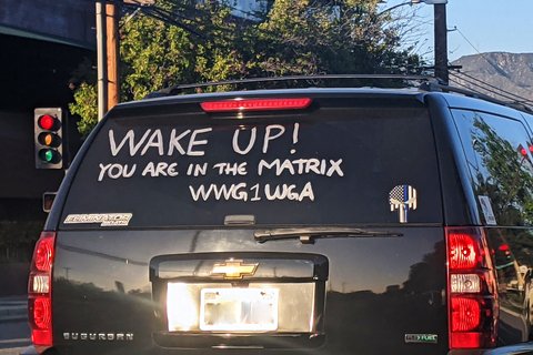 Writing on SUV rear window that reads "Wake Up! You are in the Matrix WWG1WGA"