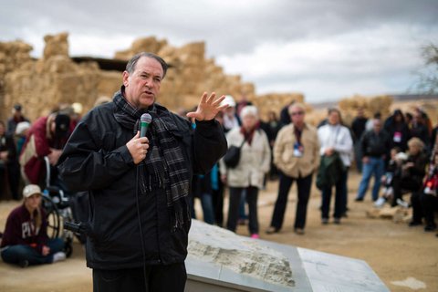 Man standing in front of crowd speaking into microphone