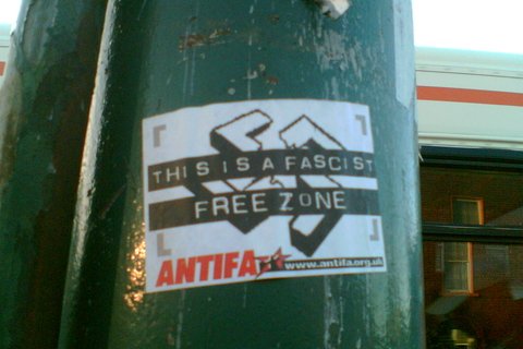 A flyer on a pillar that reads: "This is a fascist free zone. Antifa"