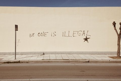 No One is Illegal painted on a wall