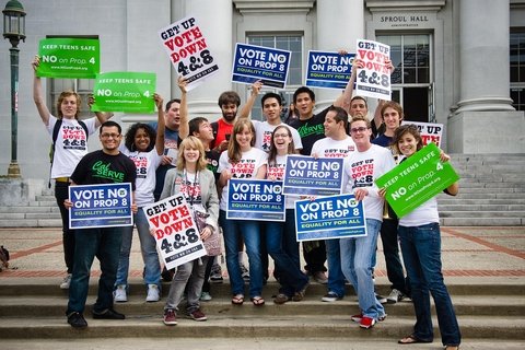 A group of people holding signs that read "Vote No on Prop 8"