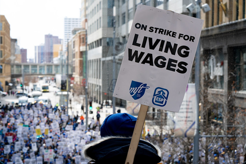 A sign that says "On strike for living wages"
