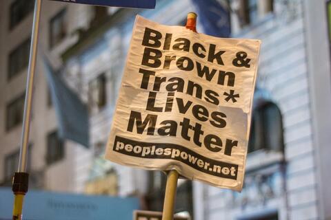 A sign that says "Black & Brown Trans Lives Matter."