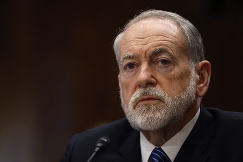 a man in a suit with a grey beard