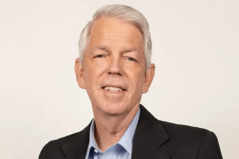 a man with grey hair in a suit