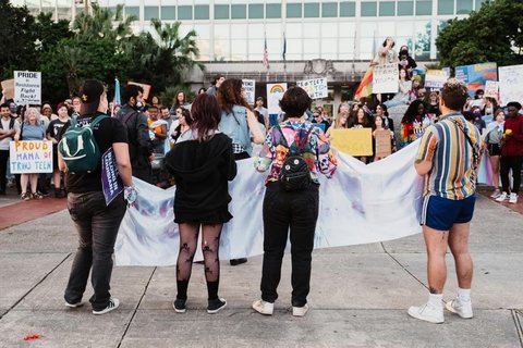 the backs of protestors in favor of trans rights
