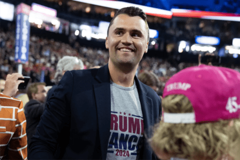 Charlie Kirk standing a crowd