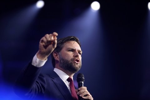 JD Vance with mic in spotlight