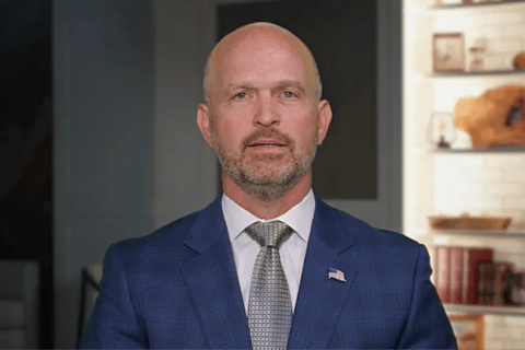 a man in a suit looking straight into the camera