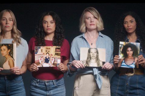 Four survivors of Jeffrey Epstein's orbit hold up pictures of themselves as teenage girls in World Without Exploitation's ad calling for Congress to pass a measure to force the Department of Justice to release the Epstein Files