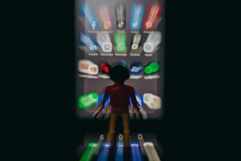 person stands in front of a giant cellphone screen